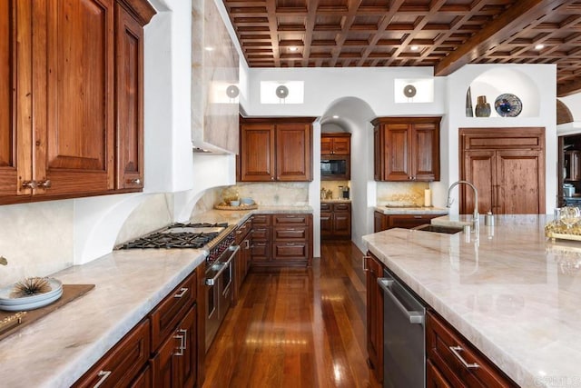 kitchen featuring coffered ceiling, sink, tasteful backsplash, appliances with stainless steel finishes, and dark hardwood / wood-style flooring