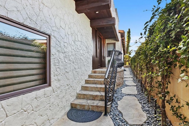 exterior space featuring stucco siding and fence
