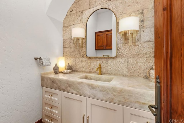 bathroom featuring decorative backsplash and vanity