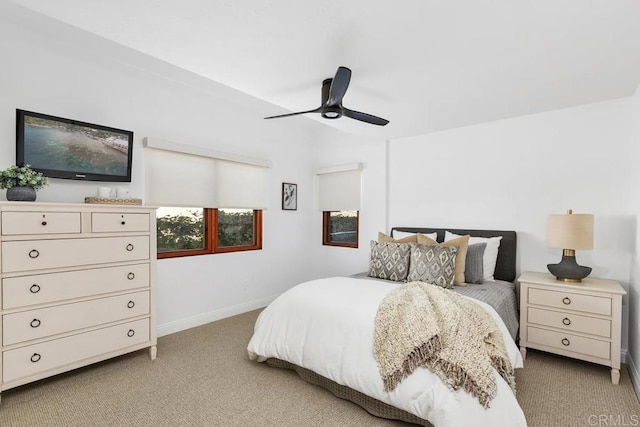 bedroom featuring baseboards, ceiling fan, and light carpet