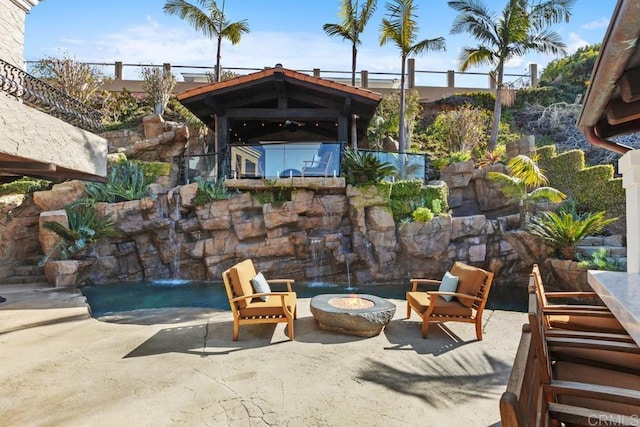 view of patio / terrace with an outdoor fire pit and a gazebo