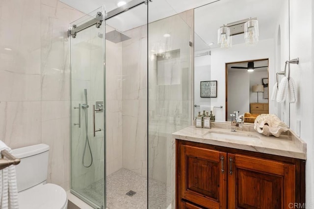 bathroom with toilet, a stall shower, and vanity