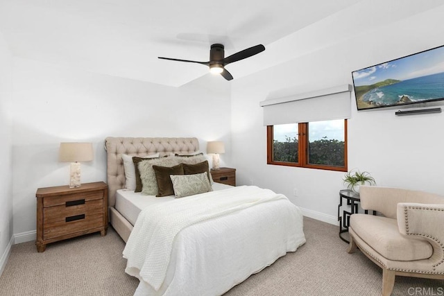 carpeted bedroom featuring baseboards and ceiling fan