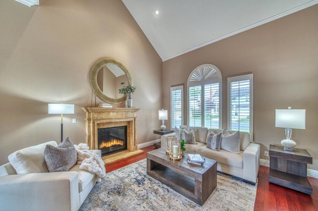 living room with crown molding, hardwood / wood-style flooring, and high vaulted ceiling