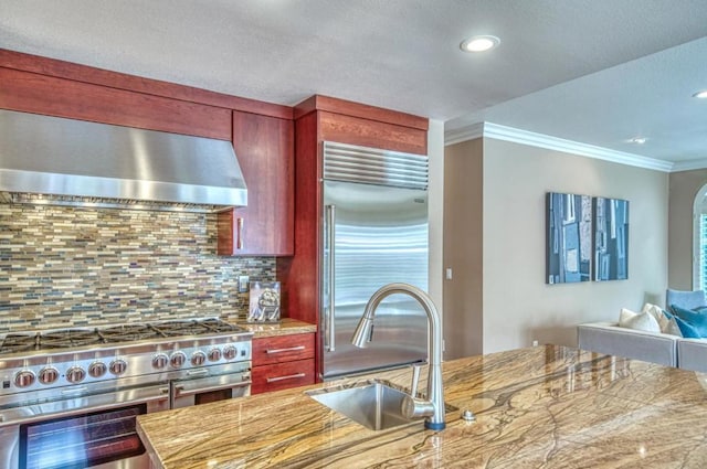 kitchen featuring sink, crown molding, high end appliances, tasteful backsplash, and exhaust hood