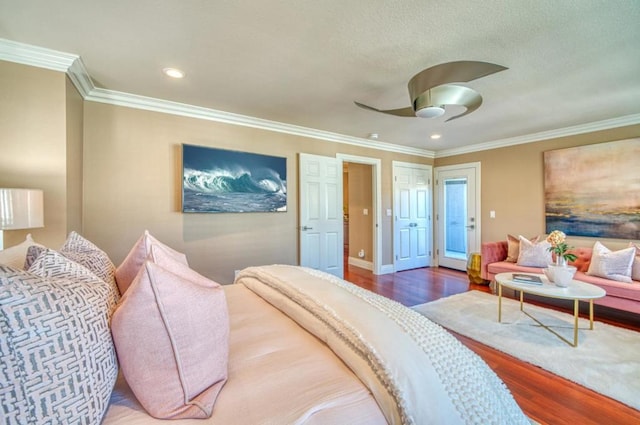 bedroom with crown molding, hardwood / wood-style floors, and ceiling fan