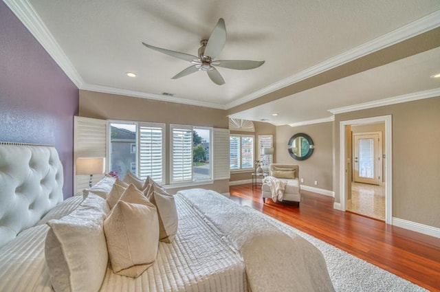 bedroom featuring hardwood / wood-style floors, crown molding, and ceiling fan