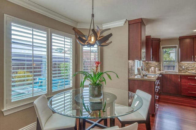 dining room featuring ornamental molding, dark hardwood / wood-style floors, and sink