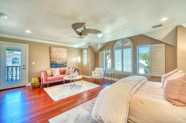 bedroom with ceiling fan, dark hardwood / wood-style floors, ornamental molding, a textured ceiling, and vaulted ceiling