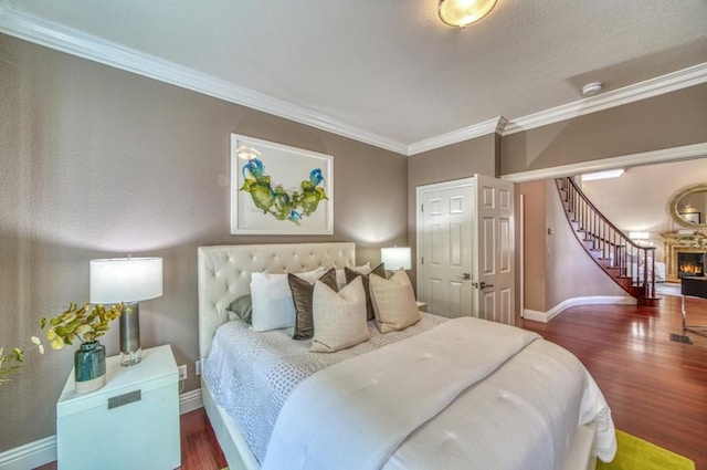 bedroom with crown molding and hardwood / wood-style floors