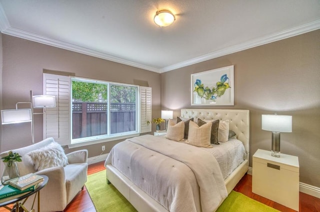 bedroom with crown molding and hardwood / wood-style floors