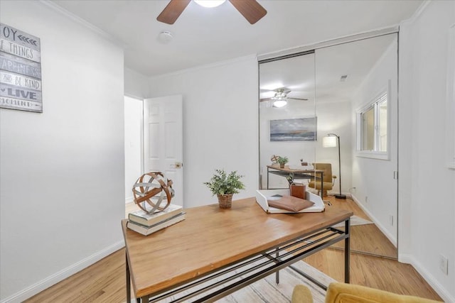 home office featuring ceiling fan, ornamental molding, and light hardwood / wood-style floors