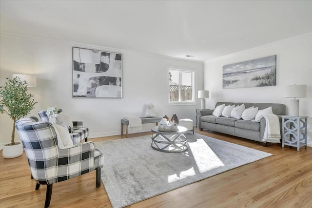 living room with hardwood / wood-style floors and ornamental molding