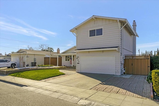 front of property featuring a garage and a front lawn