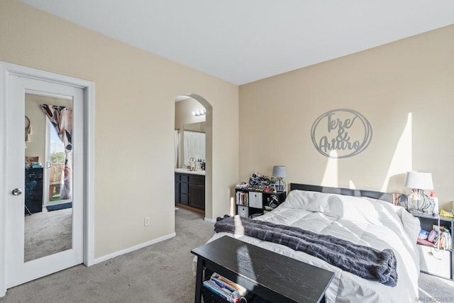 carpeted bedroom featuring ensuite bathroom