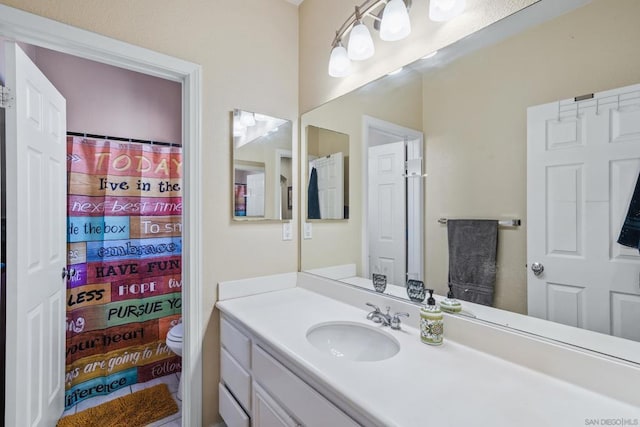 bathroom featuring vanity, toilet, and a shower with shower curtain