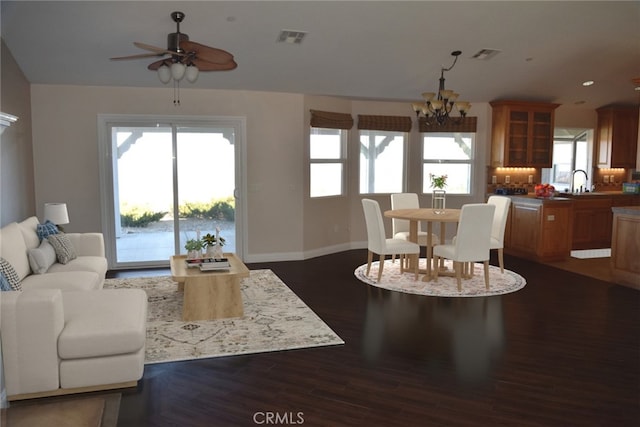 living area featuring dark wood-type flooring, recessed lighting, visible vents, and baseboards