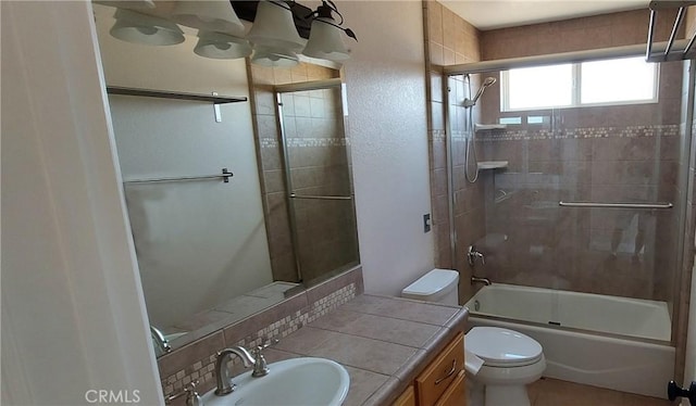 full bath featuring combined bath / shower with glass door, vanity, and toilet