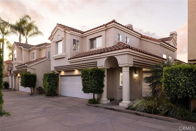 mediterranean / spanish house featuring a garage