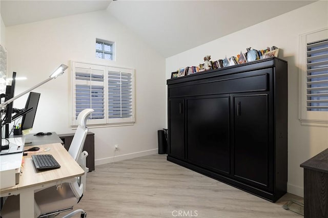 office space with vaulted ceiling and light hardwood / wood-style floors