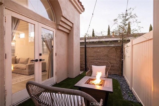 exterior space featuring french doors and an outdoor fire pit