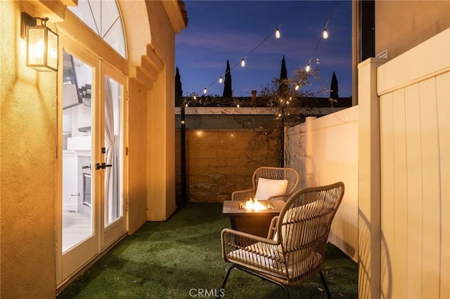 exterior space featuring an outdoor fire pit and french doors