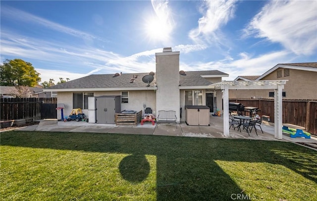 back of property featuring a yard, a pergola, and a patio