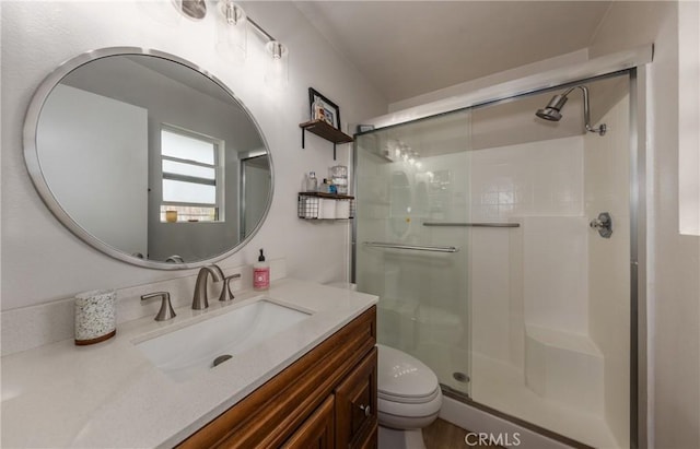 bathroom featuring vanity, toilet, and an enclosed shower