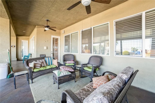 view of patio / terrace with ceiling fan and an outdoor living space