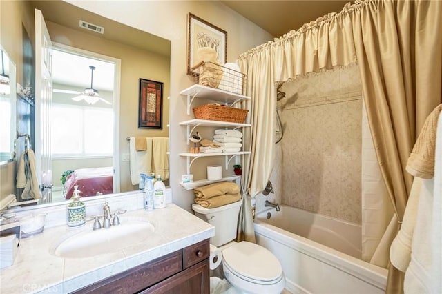 full bathroom featuring ceiling fan, vanity, toilet, and shower / tub combo