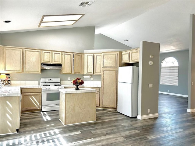 kitchen featuring lofted ceiling, white appliances, a center island, tile countertops, and light brown cabinets