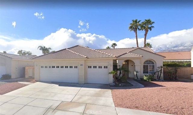 mediterranean / spanish house with a garage