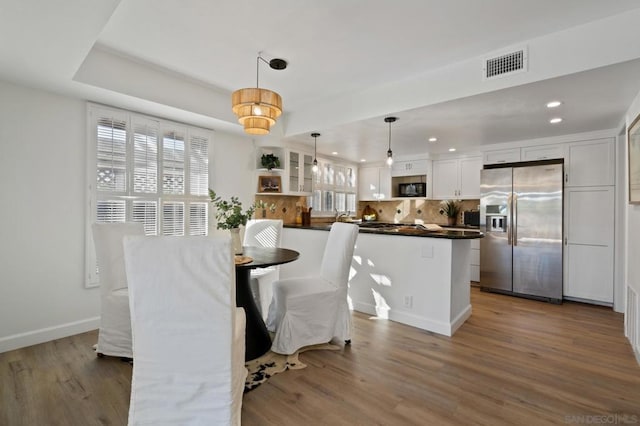 dining room featuring dark hardwood / wood-style flooring and a raised ceiling