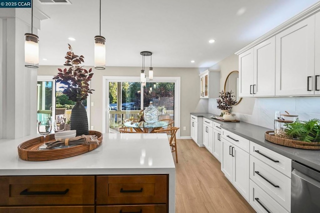 kitchen featuring dishwasher, pendant lighting, a healthy amount of sunlight, light hardwood / wood-style floors, and white cabinets