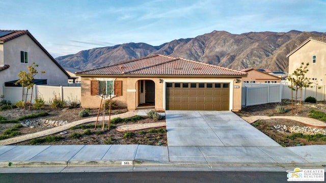 view of front of house with a garage and a mountain view