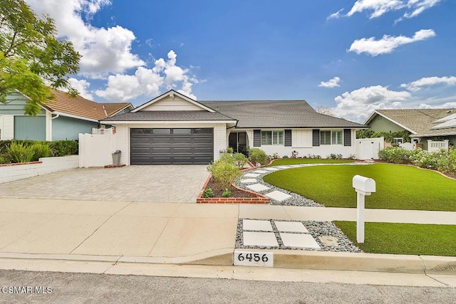 ranch-style home with a garage and a front yard