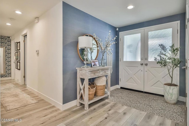 foyer featuring french doors and light hardwood / wood-style flooring