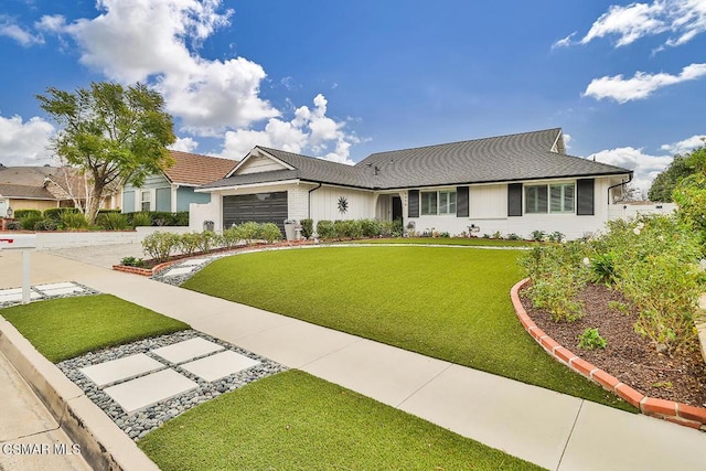 ranch-style home with a garage and a front lawn