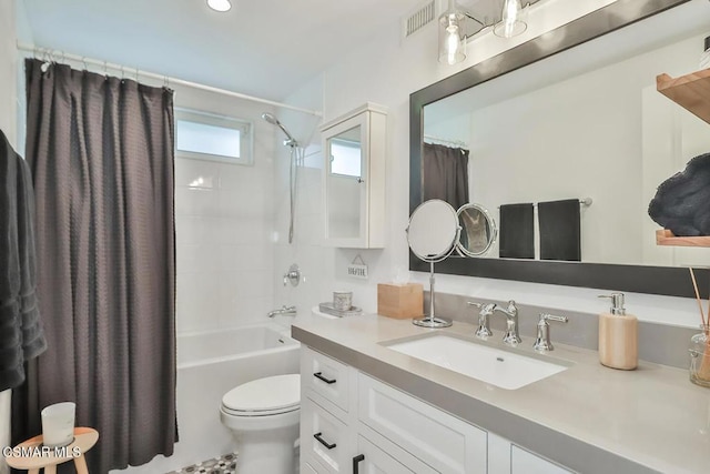 full bathroom featuring vanity, shower / tub combo, and toilet