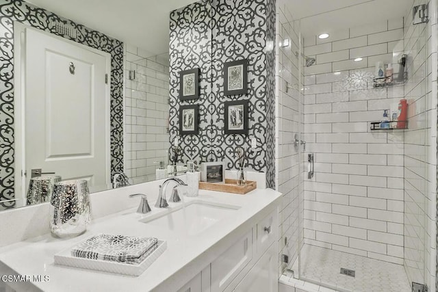 bathroom with a shower with door and vanity