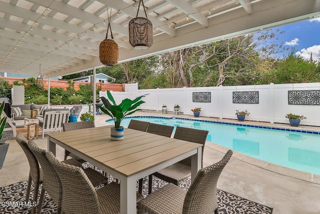 view of swimming pool with ceiling fan, an outdoor living space, and a patio area