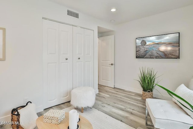 bedroom featuring light hardwood / wood-style floors and a closet