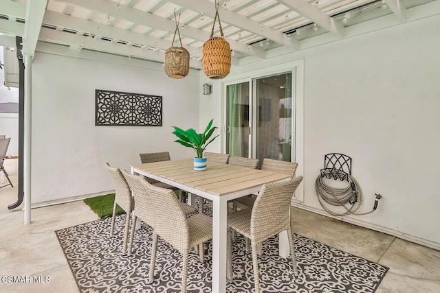 dining space featuring beam ceiling