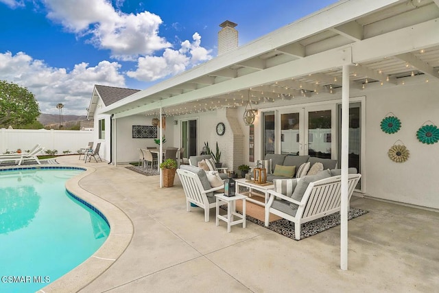 view of pool with french doors, an outdoor hangout area, and a patio area