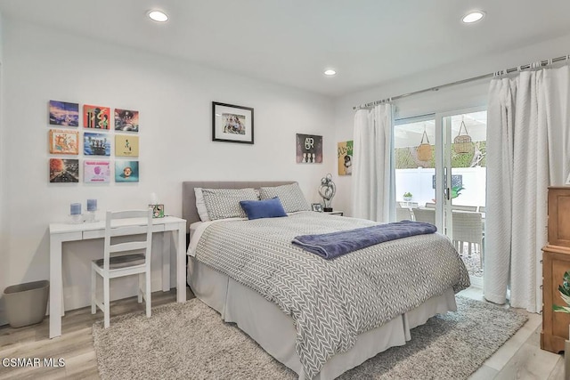 bedroom with access to exterior and light hardwood / wood-style floors