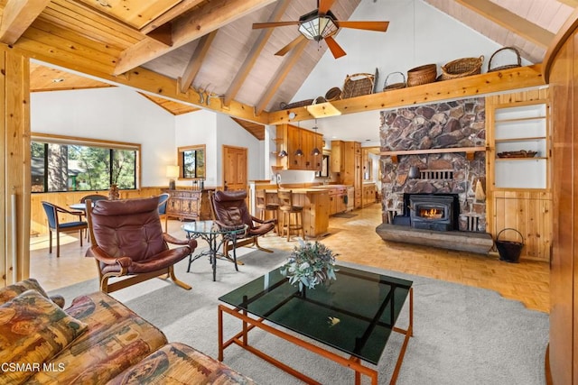 living room with beamed ceiling, wooden walls, high vaulted ceiling, and light parquet floors