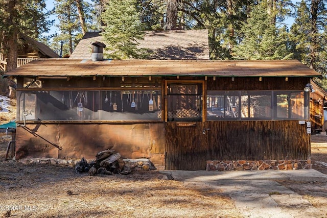 back of house featuring a sunroom