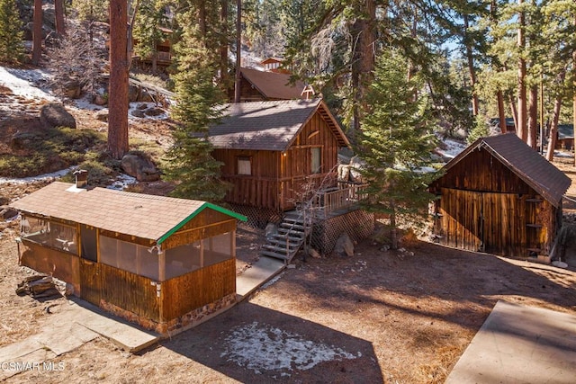 view of yard featuring a wooden deck and an outdoor structure