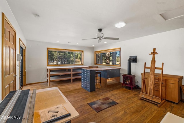 interior space featuring wood-type flooring and a wood stove