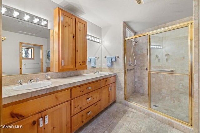 bathroom featuring vanity, tile walls, and walk in shower